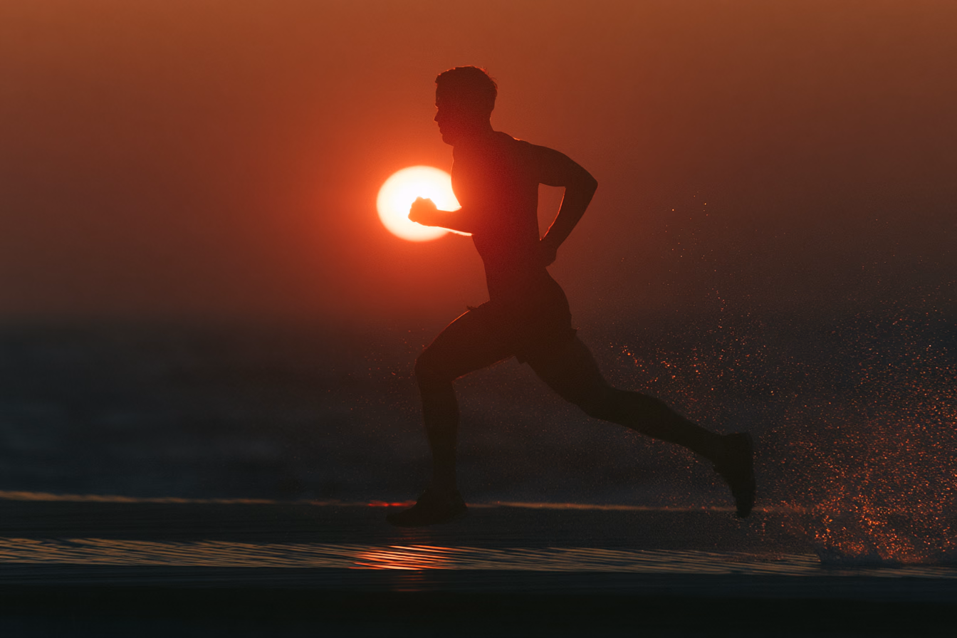 A runner mid-stride on a boardwalk before sunrise