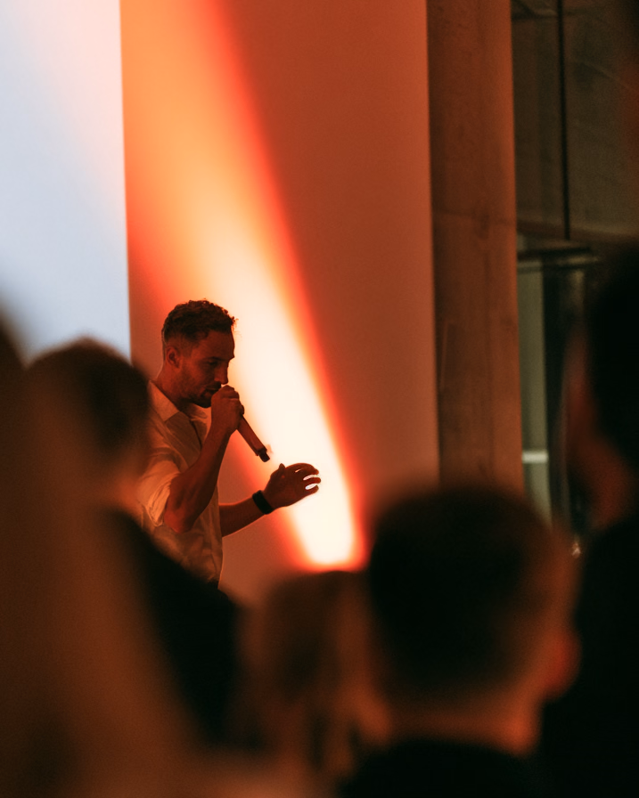 Ein Speaker mit Mikrofon vor dem Publikum bei einem Chapter-Talk